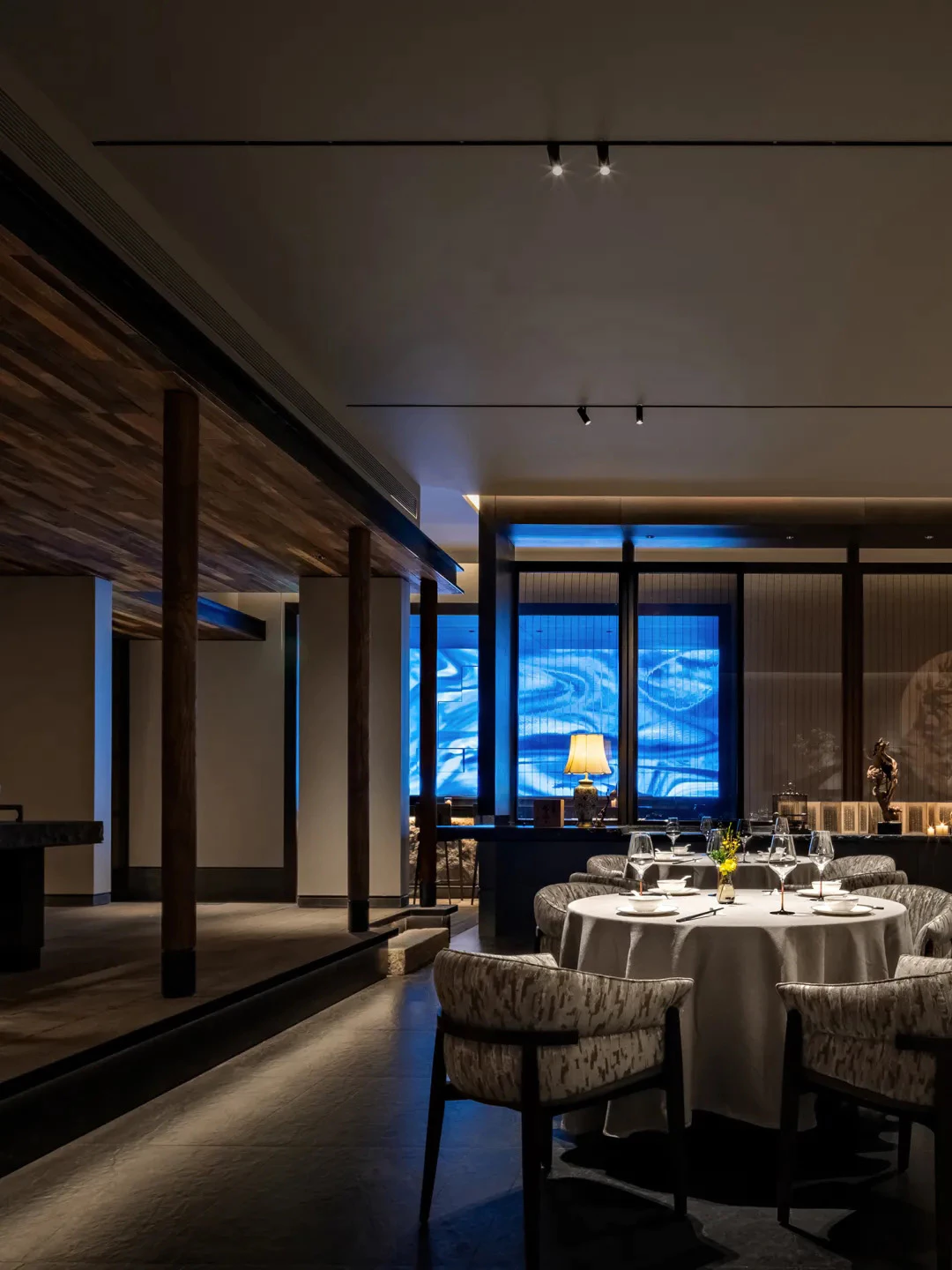 Upscale restaurant dining room with blue ambient lighting