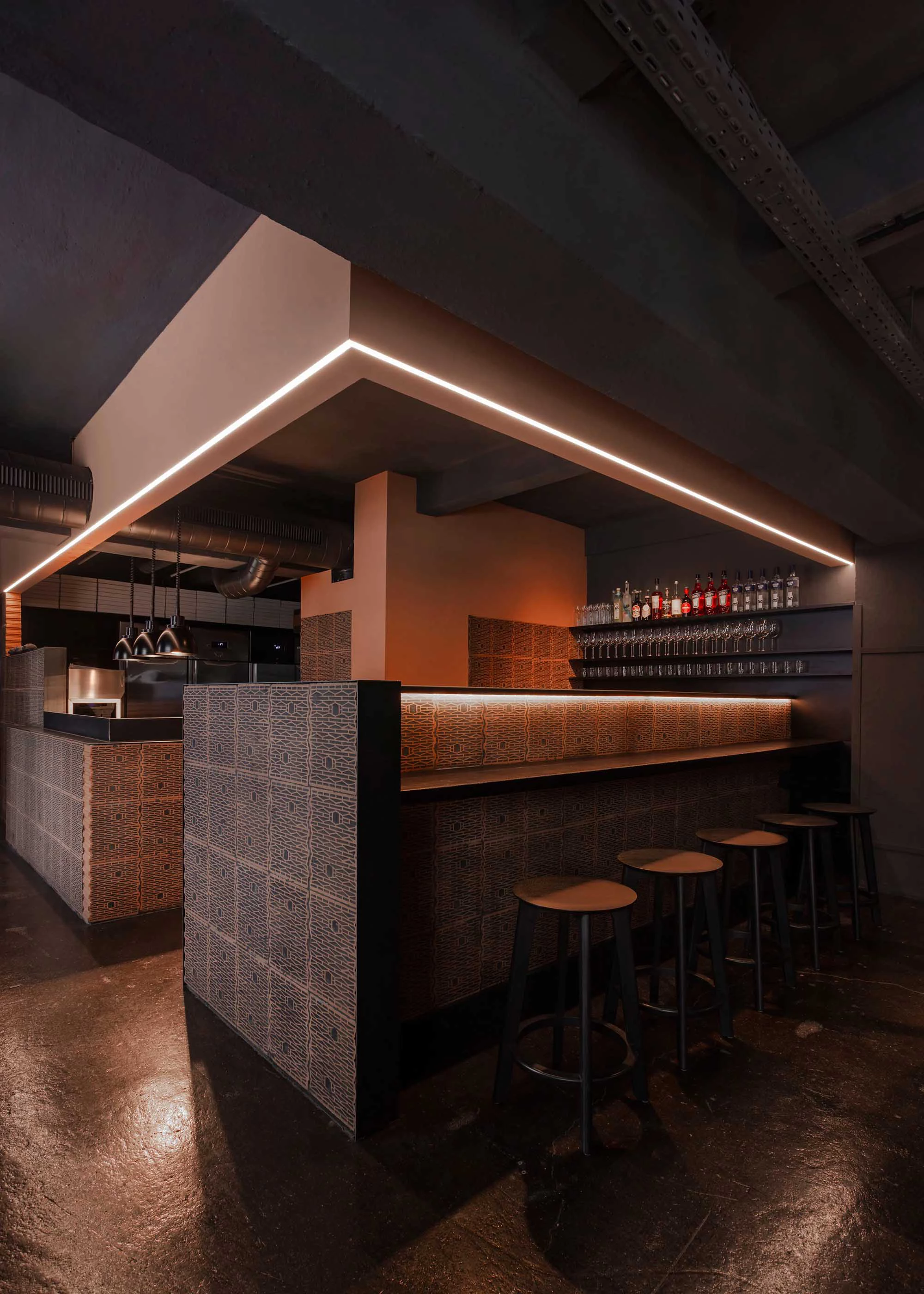 Industrial bar with patterned tile counter and LED strip lighting