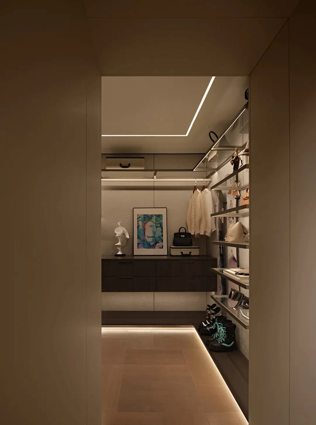 Luxury walk-in closet with LED cove lighting and open shelving